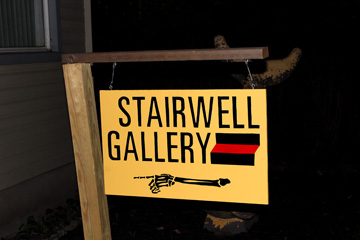 Sign indicating the way to the Stairwell Gallery